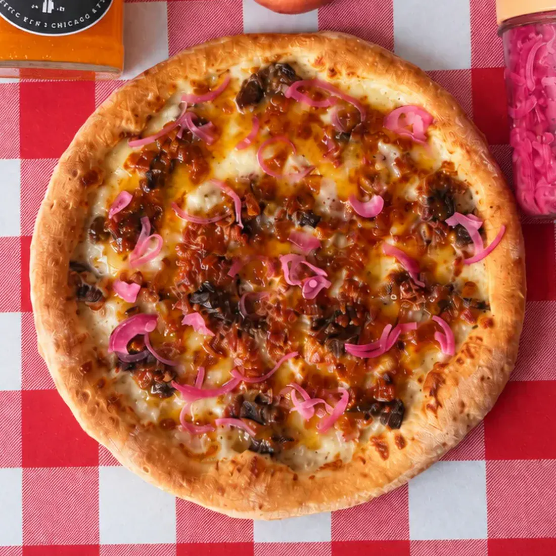 Big City Pizza's Peach Pitmaster pizza with brisket, peach glaze, and pickled red onions.