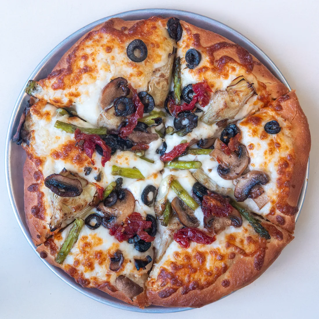 Joe Bologna's Ortolana Classica pizza with asparagus, mushrooms, artichokes, roasted tomatoes, black olives, and cheese.