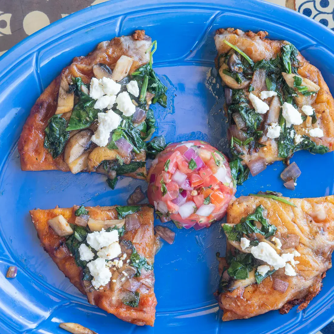 Mi Pequeña Hacienda's Veggie Pizza with mushrooms, onions, spinach, and queso.