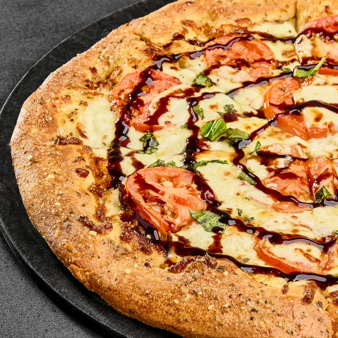 Parlour Pizza's Caprese pizza with fresh mozzarella, tomatoes, basil, and balsamic glaze.