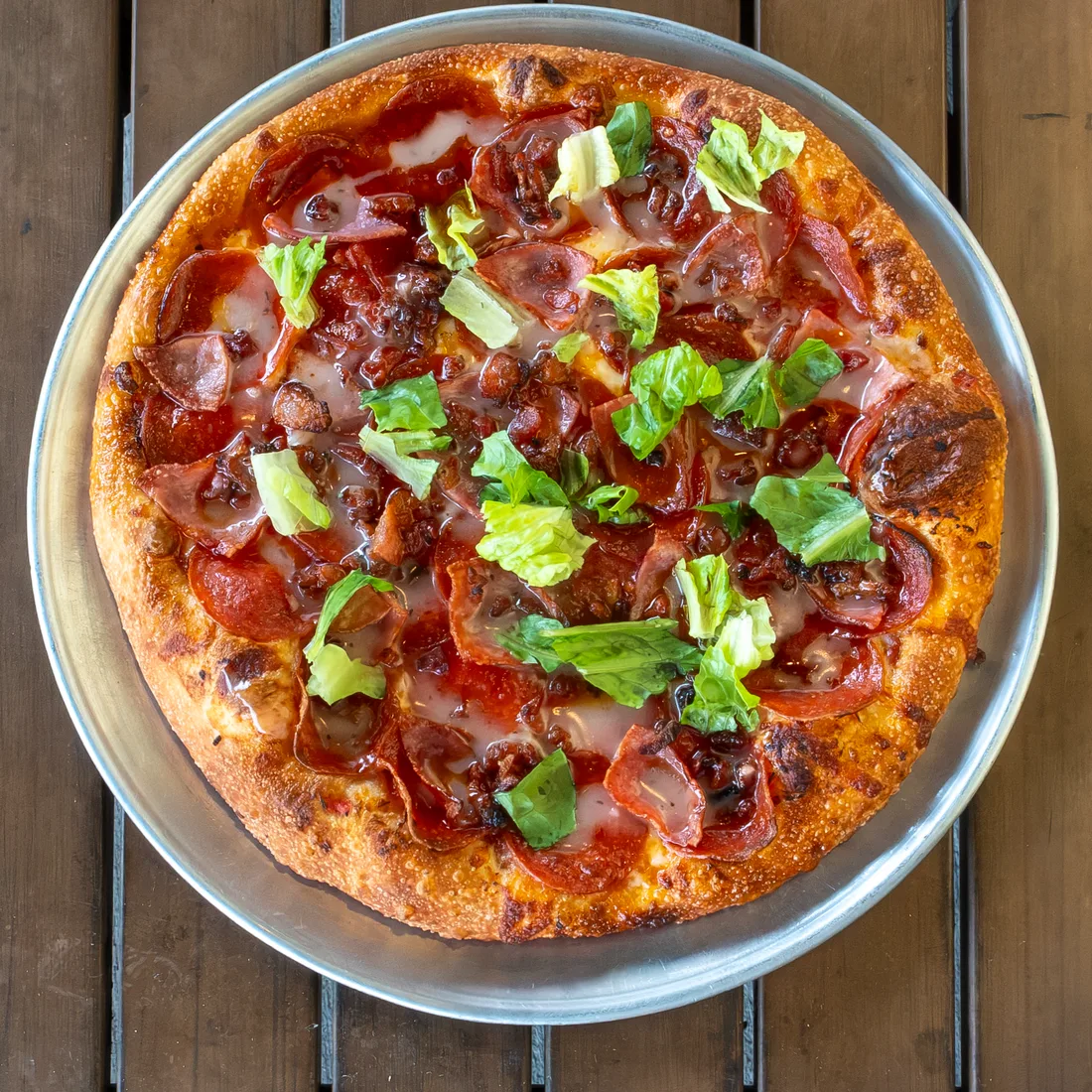 Pie Five's Deli Meat pizza with pepperoni, ham, bacon, lettuce, and vinaigrette.