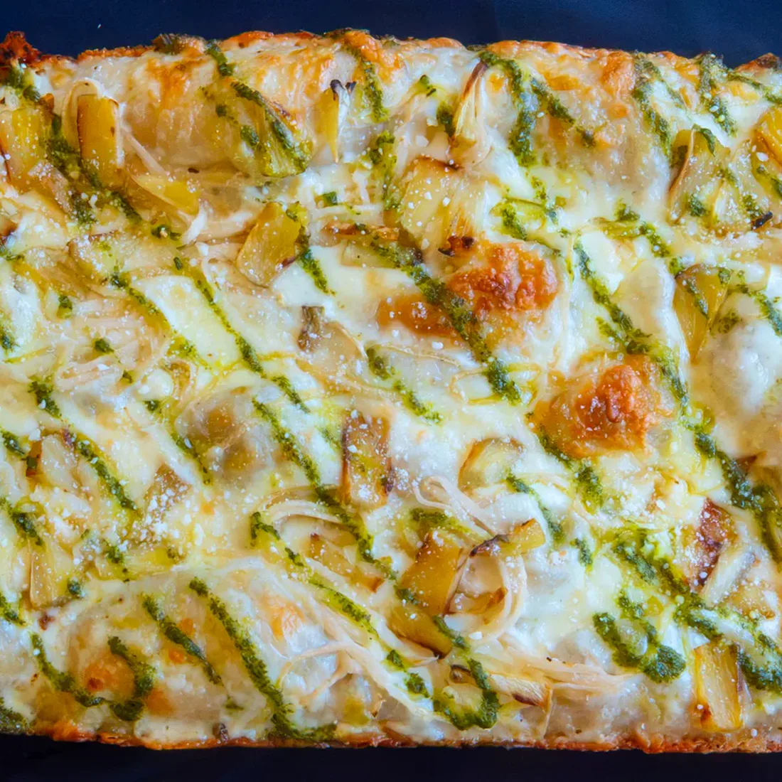 Rise Up's Comeback Kid pizza with pickled jicama, charred pineapple, and cilantro-lime sauce.
