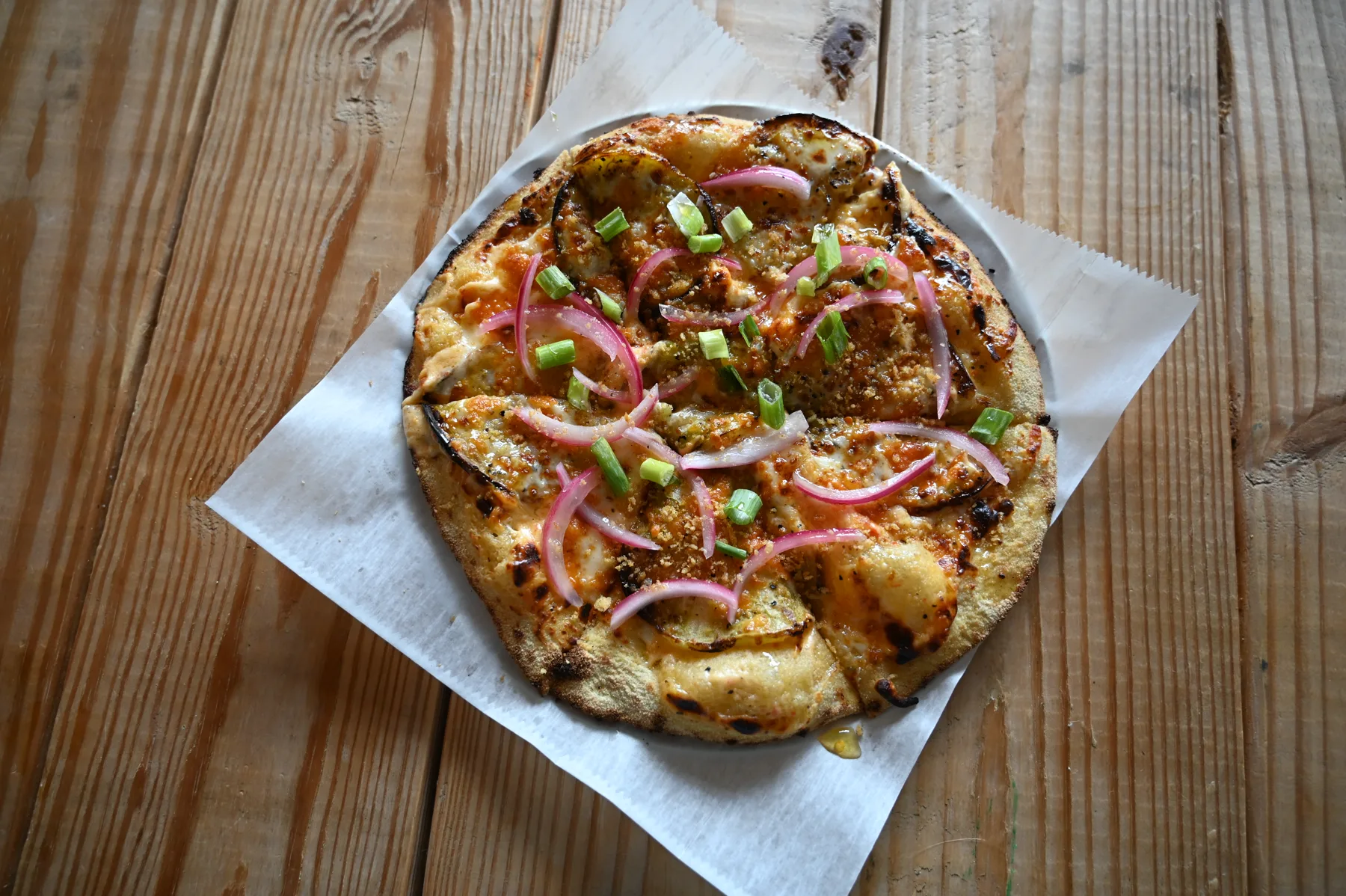 Rolling Oven's Bluegrass Peach Heat pizza with country ham, charred peach compote, pickled jalapeños, and scallions.