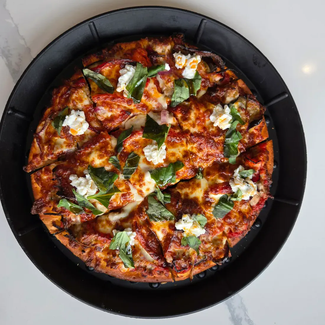Rosati's Kuz’s Italian Flair con salsiccia pizza with homemade Italian sausage, roasted eggplant, red bell pepper, red onion, mozzarella, ricotta, Pecorino Romano, oregano, basil, and Calabrian chili oil.
