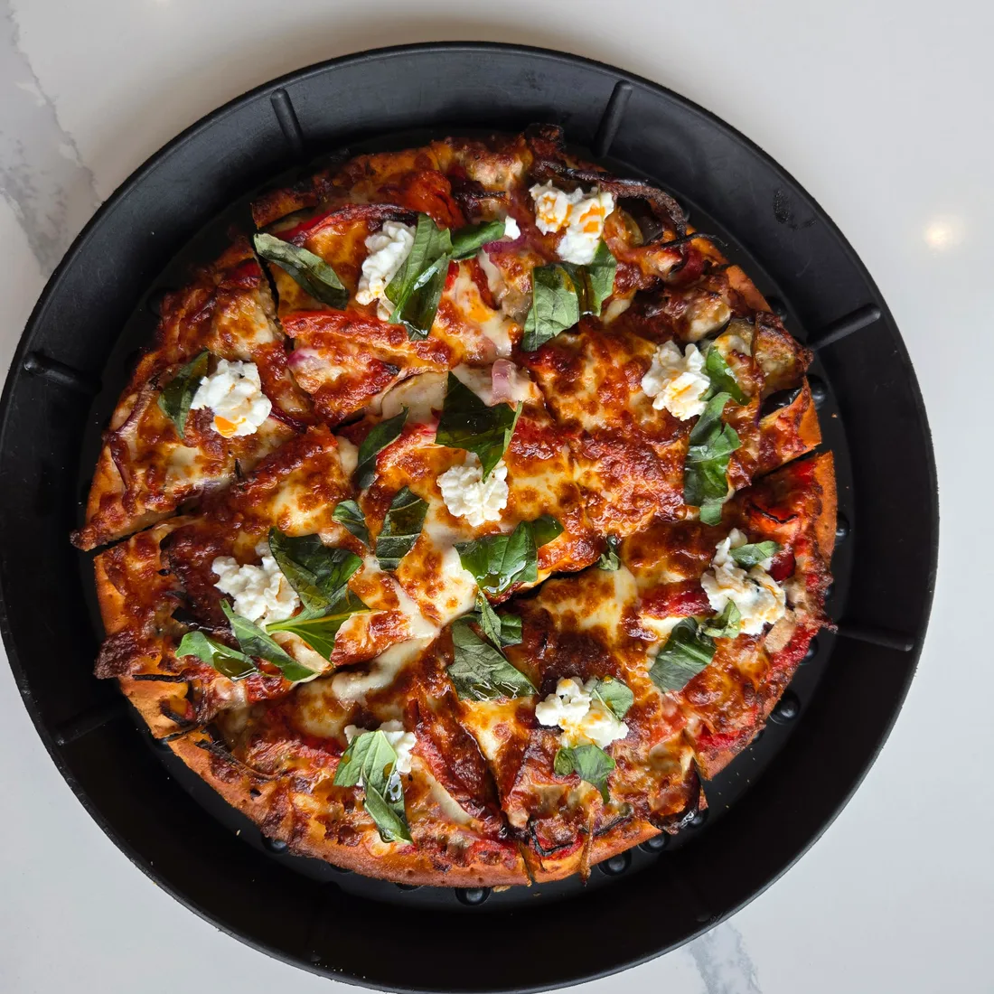 Rosati's Kuz’s Italian Flair pizza with roasted eggplant, red bell pepper, red onion, mozzarella, ricotta, Pecorino Romano, oregano, basil, and Calabrian chili oil.